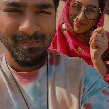 Chan and Sneha in a selfie, both covered in Holi colours